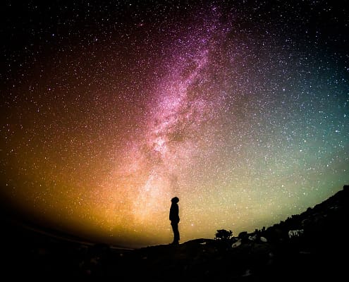 Man looking up into a starry sky.